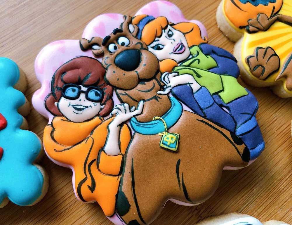 Velma and Daphne tickling Scooby-Doo