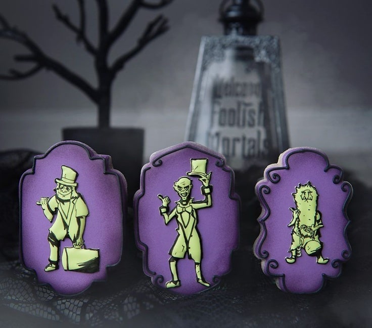 Three glow in the dark cookies each one featuring one hitchhiking ghost