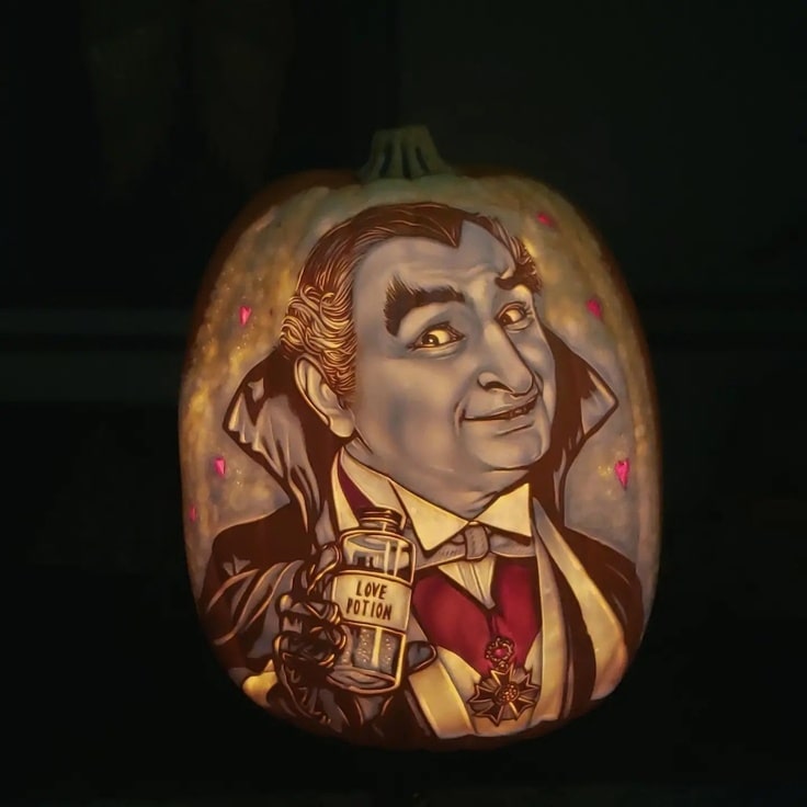 Pumpkin carving of Grandpa Munster holding a love potion