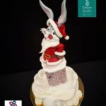 This cake has Bugs Bunny dressed as Santa Claus and going down a chimney.