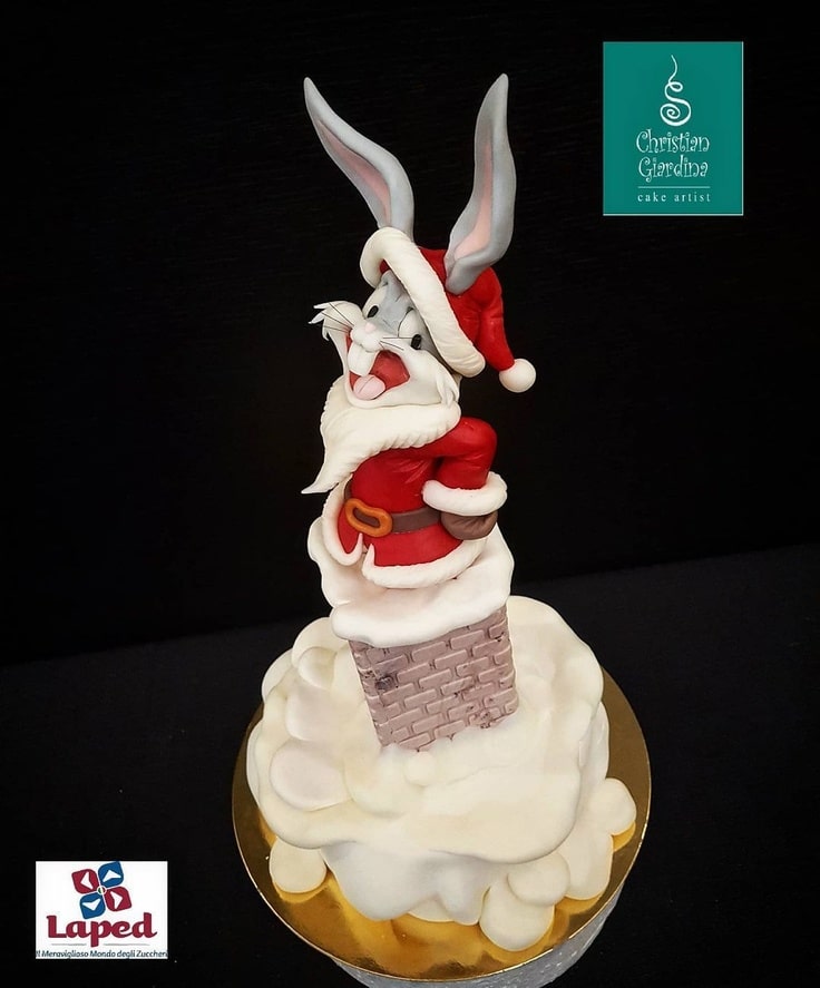 This cake has Bugs Bunny dressed as Santa Claus and going down a chimney.