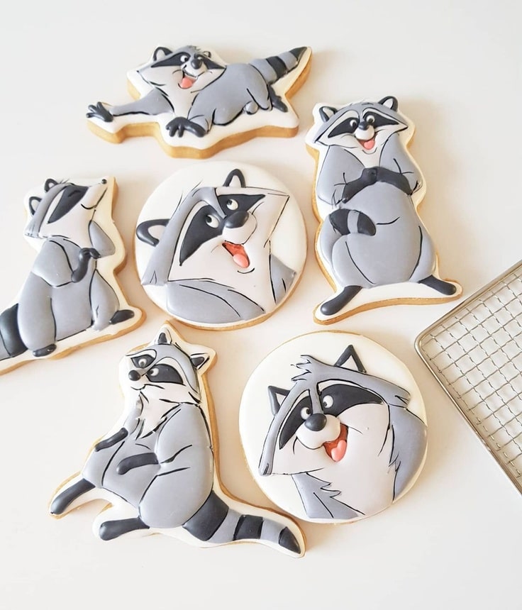 These cookies feature Meeko, the racoon from Pocahontas, in various poses