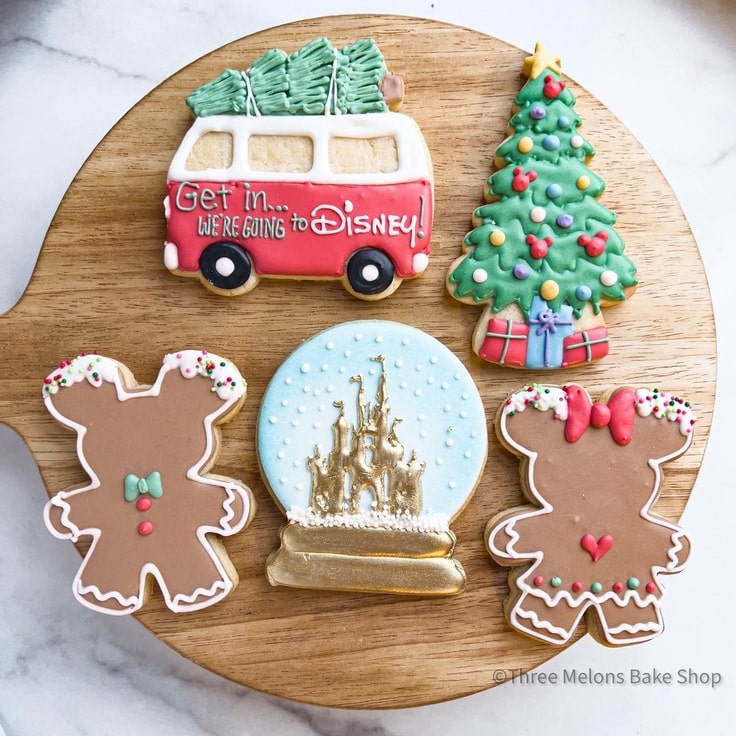 These Disney Christmas Trip Cookies feature gingerbread Mickey & Minnie Mouse, a snow globe with the castle in it, a Christmas Tree & a van announcing that they're going to Disney World