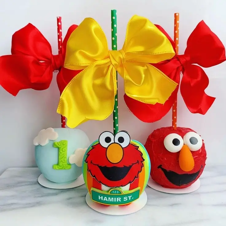 3 Elmo Chocolate Covered Apples. Each with a unique design.