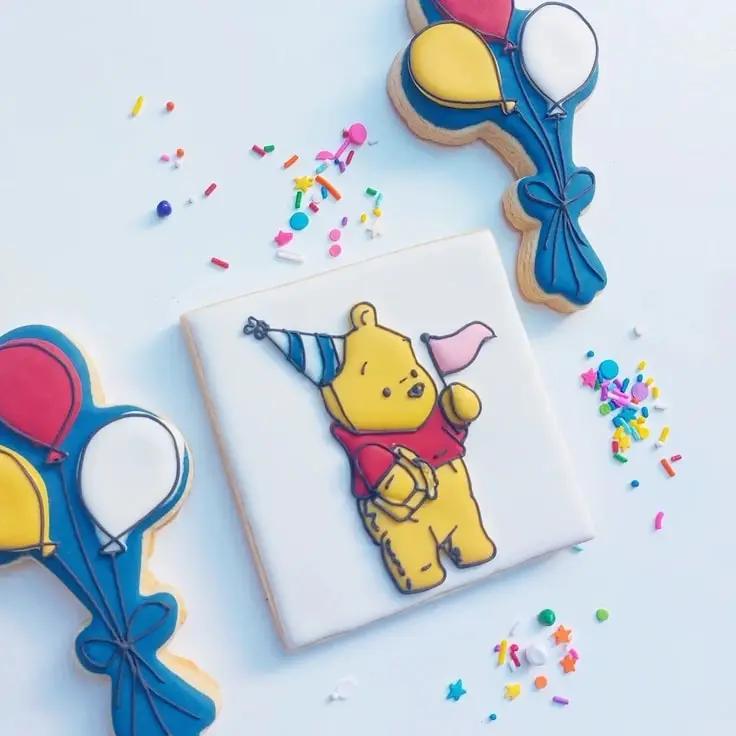 This adorable cookie features Pooh wearing a birthday hat and waving a pendant.