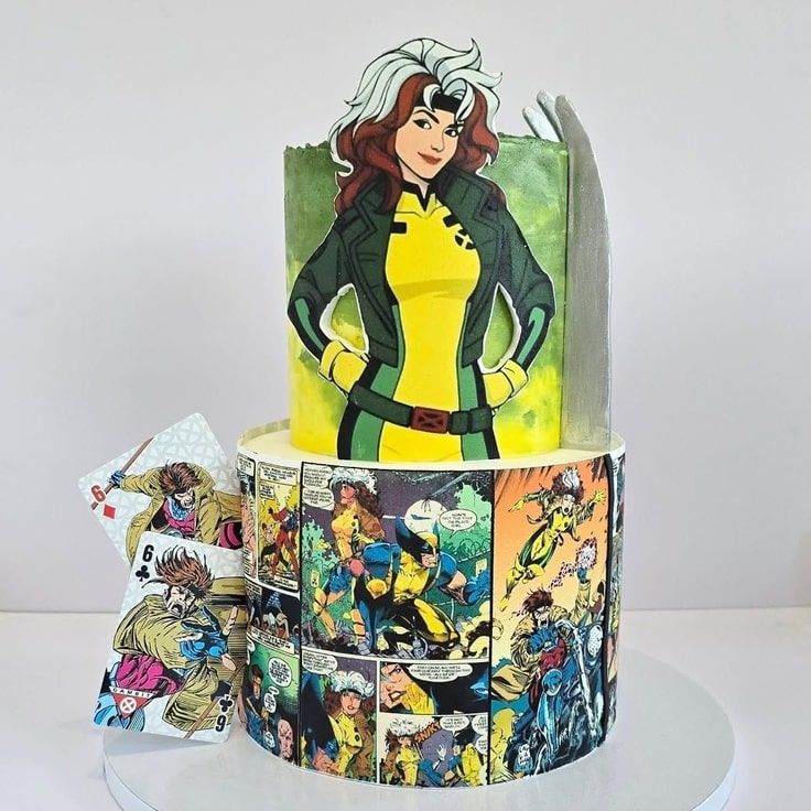 This is a two tier cake. The top tier has Rogue on it. The bottom tear has a bunch of comic book panels.